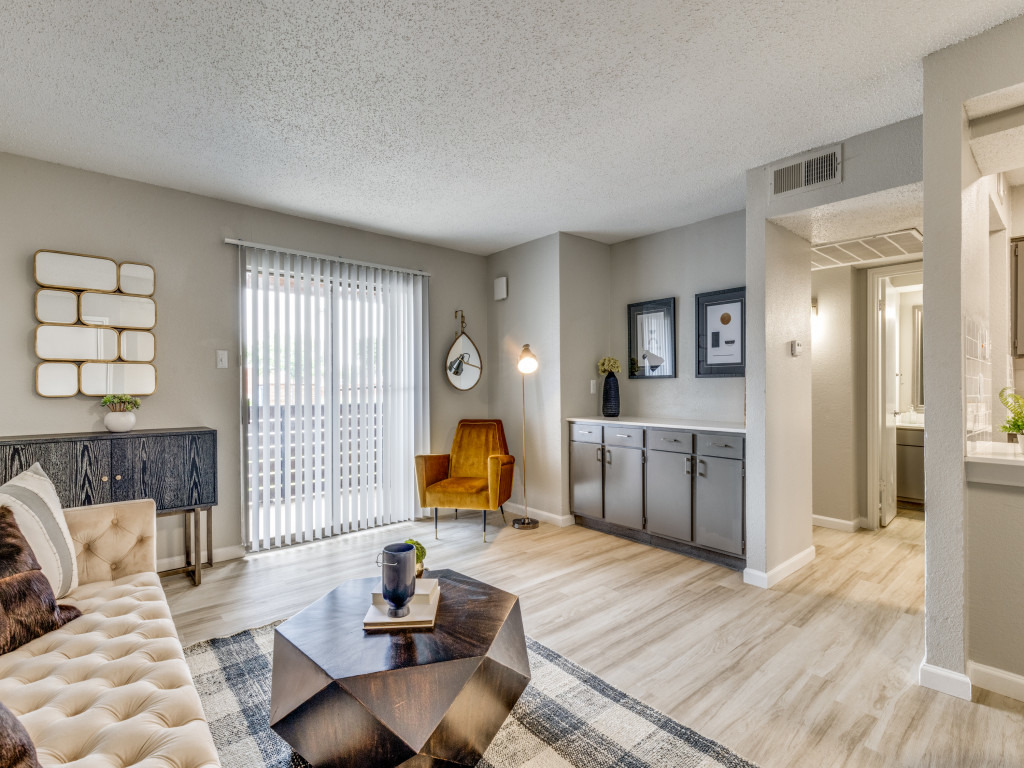 the living room has hardwood floors and a large window at The  Durham